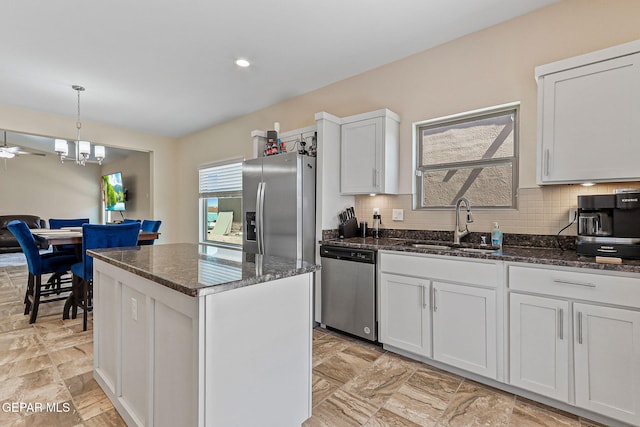 11589 Flor Cadillo, Socorro, TX 79927 - kitchen with appliances with stainless steel finishes, a sink, dark stone countertops, a kitchen island, and white cabinetry