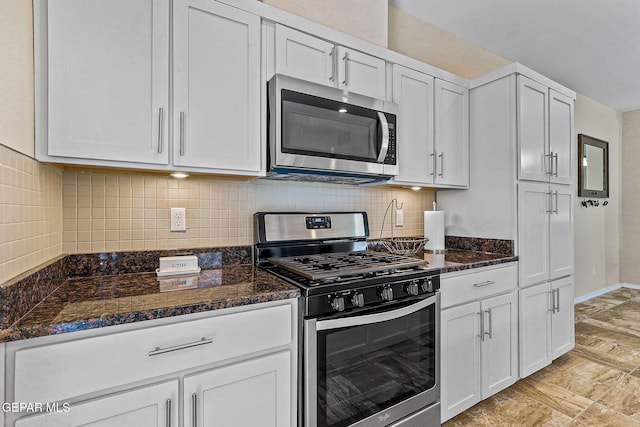 11589 Flor Cadillo, Socorro, TX 79927 - kitchen with appliances with stainless steel finishes, dark stone countertops, white cabinetry, and backsplash