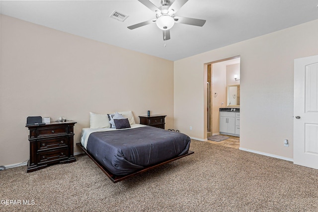 11589 Flor Cadillo, Socorro, TX 79927 - bedroom featuring light carpet, baseboards, ceiling fan, and ensuite bath