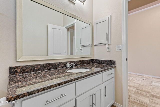 11589 Flor Cadillo, Socorro, TX 79927 - bathroom with vanity, baseboards, and marble look tile flooring