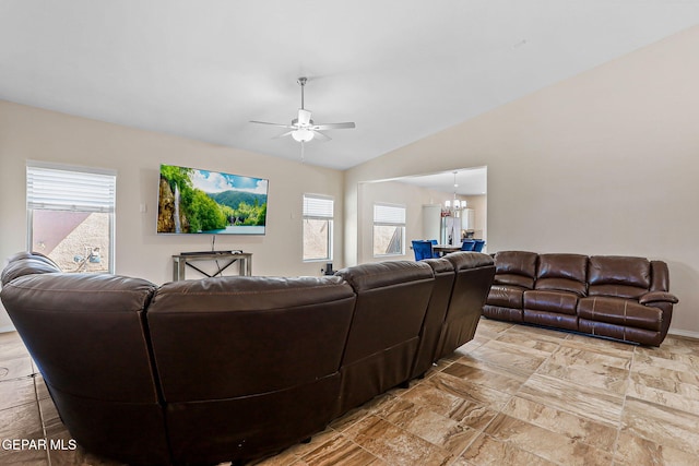 11589 Flor Cadillo, Socorro, TX 79927 - living area with a ceiling fan, healthy amount of natural light, a chandelier, vaulted ceiling, and light stone finish floors