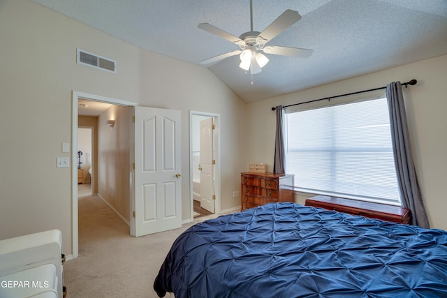 13261 Walker Post Ave, El Paso, TX 79928 - bedroom with vaulted ceiling, light carpet, ceiling fan, and connected bathroom