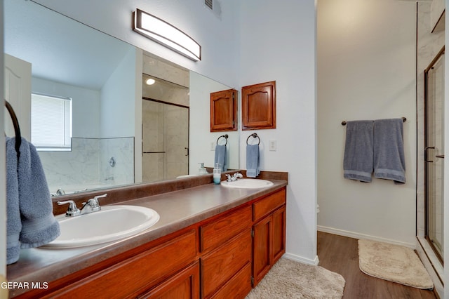 13261 Walker Post Ave, El Paso, TX 79928 - bathroom featuring a stall shower, double vanity, and wood finished floors