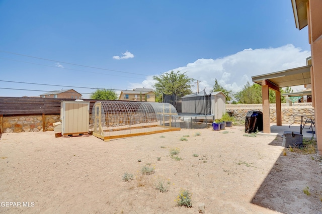 13261 Walker Post Ave, El Paso, TX 79928 - fenced backyard featuring a storage unit and a patio area