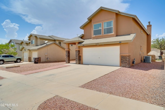 13261 Walker Post Ave, El Paso, TX 79928 - view of front of house featuring stucco siding, a garage, stone siding, and concrete driveway
