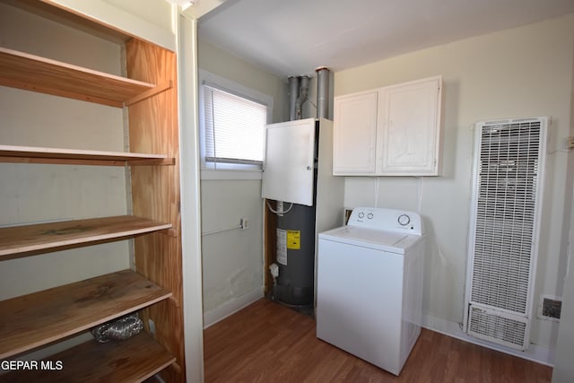 1275 Prospect St, El Paso, TX 79902 - laundry area with washer / clothes dryer, a heating unit, cabinet space, wood finished floors, and baseboards