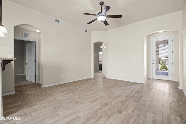 14391 Loma Esmeralda, El Paso, TX 79938 - empty room with arched walkways, a ceiling fan, and light wood finished floors