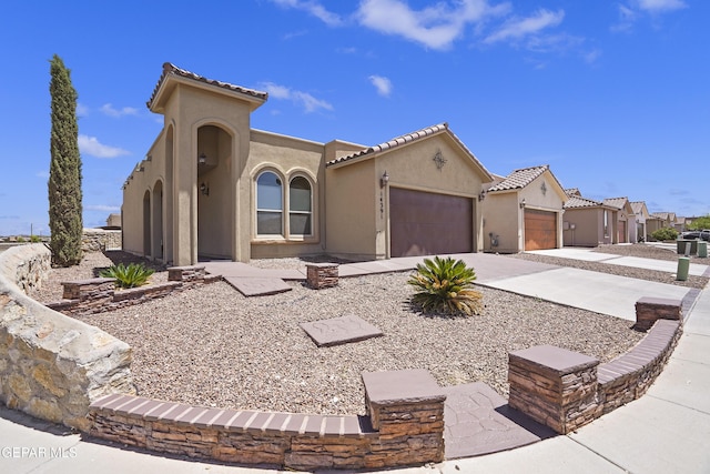 14391 Loma Esmeralda, El Paso, TX 79938 - mediterranean / spanish house with an attached garage, stucco siding, driveway, and a tile roof