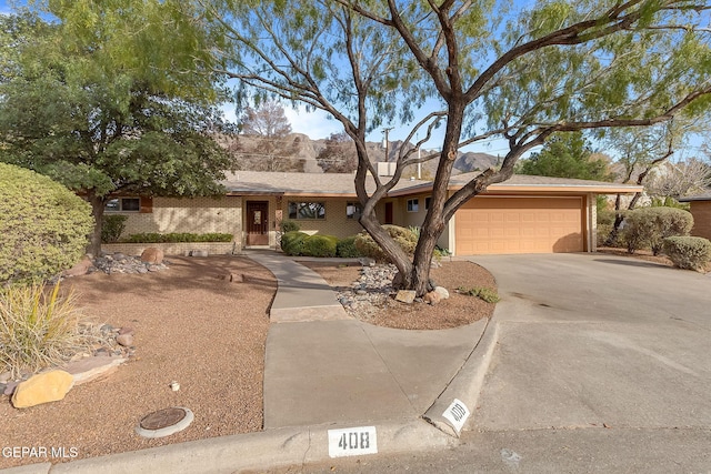 408 Spring Hill Cir, El Paso, TX 79912 - view of front facade with an attached garage, driveway, and brick siding