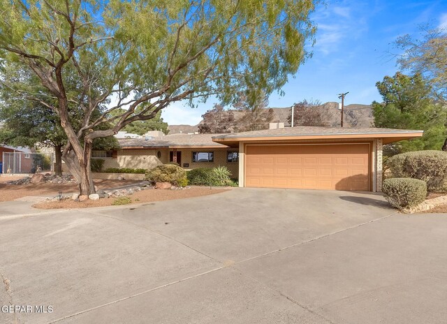 408 Spring Hill Cir, El Paso, TX 79912 - view of front of property featuring concrete driveway, brick siding, and an attached garage