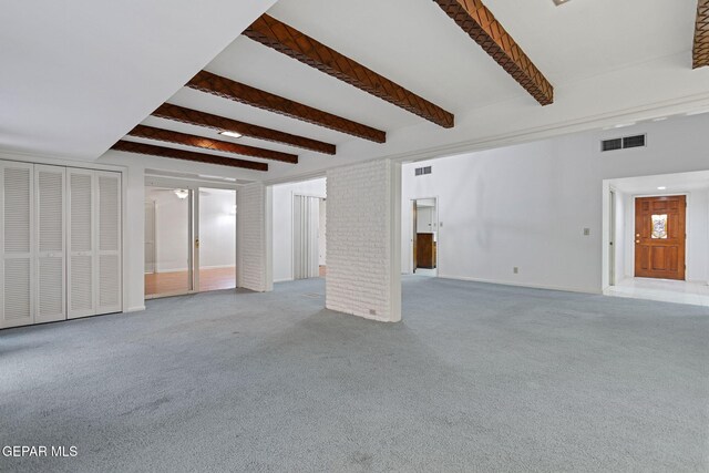 408 Spring Hill Cir, El Paso, TX 79912 - unfurnished living room featuring beam ceiling and light carpet