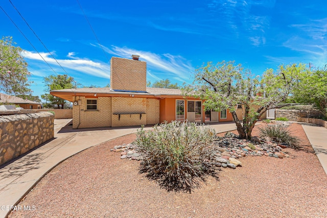 408 Spring Hill Cir, El Paso, TX 79912 - view of front of home featuring a chimney, a patio, and brick siding