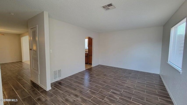 3541 Al Roberts Dr, El Paso, TX 79936 - empty room featuring arched walkways and wood tiled floors