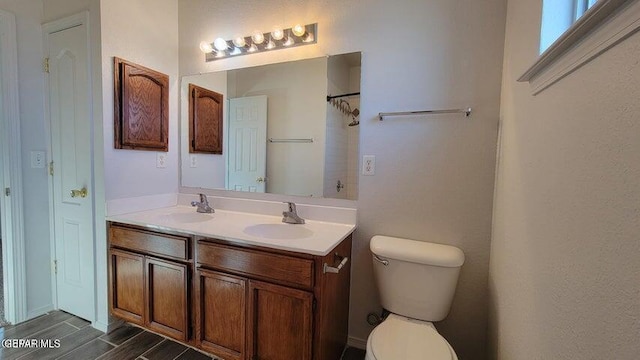 3541 Al Roberts Dr, El Paso, TX 79936 - full bath with double vanity, toilet, wood finished floors, and a shower