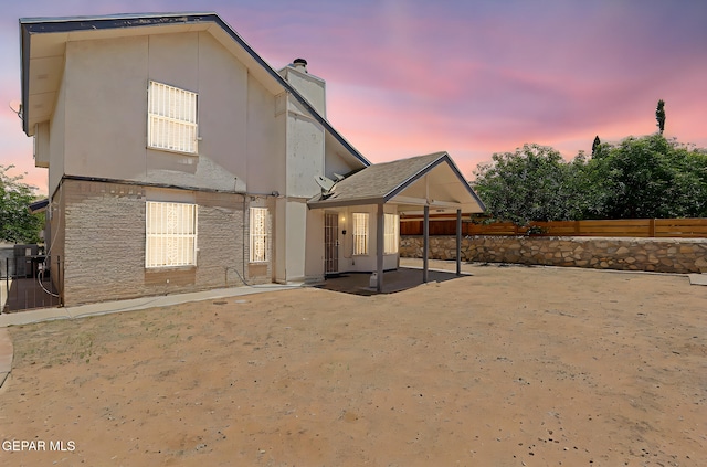11364 Crater Lake Ave, El Paso, TX 79936 - rear view of property with a chimney, a patio area, a fenced backyard, central air condition unit, and stucco siding