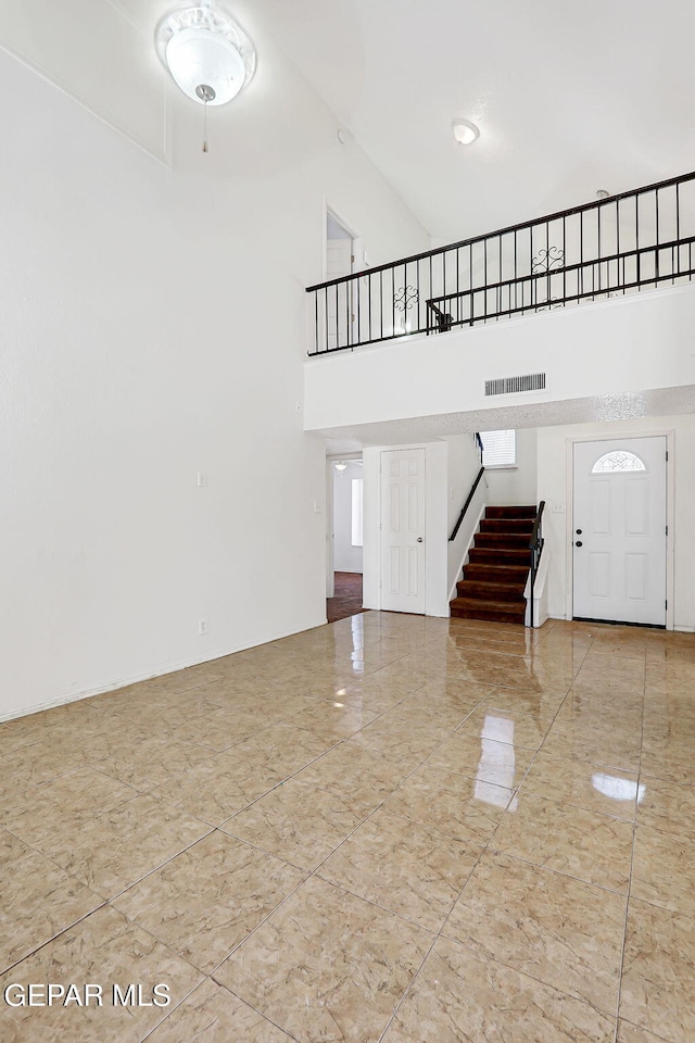 11364 Crater Lake Ave, El Paso, TX 79936 - entryway featuring a high ceiling and stairway