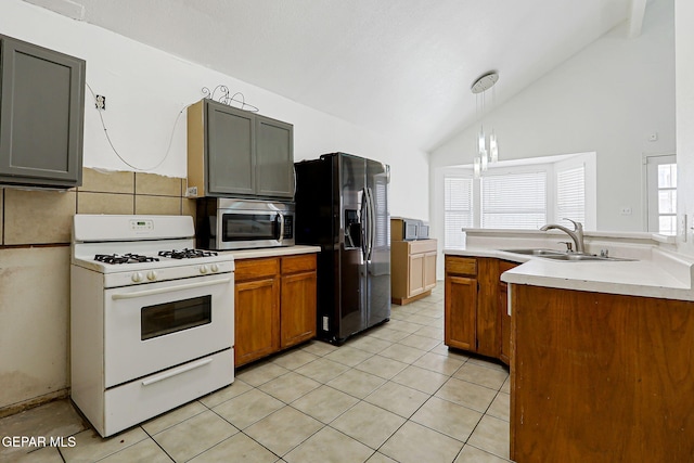 11364 Crater Lake Ave, El Paso, TX 79936 - kitchen featuring white range with gas cooktop, stainless steel microwave, refrigerator with ice dispenser, a sink, and lofted ceiling