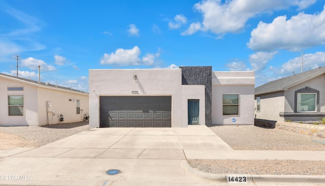 14423 Kayla Mia Dr, El Paso, TX 79938 - view of front of home with a garage, stucco siding, and concrete driveway