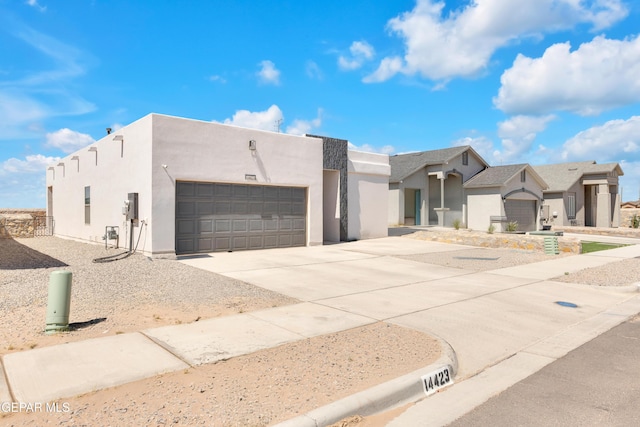 14423 Kayla Mia Dr, El Paso, TX 79938 - view of front facade with stucco siding, a garage, and driveway