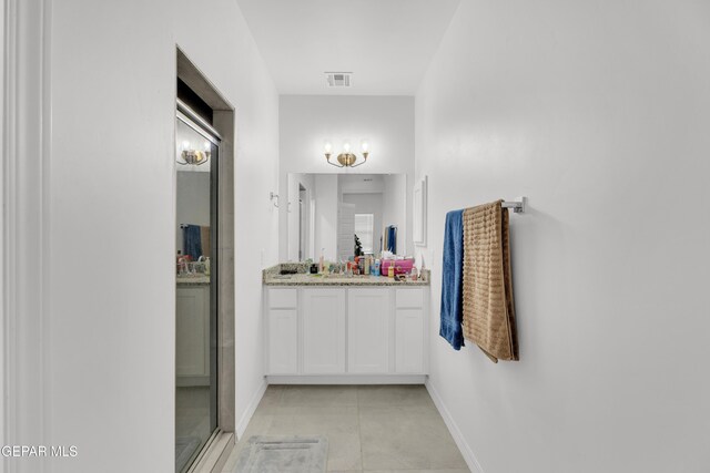 14423 Kayla Mia Dr, El Paso, TX 79938 - bathroom featuring vanity, baseboards, tile patterned flooring, and a shower with door