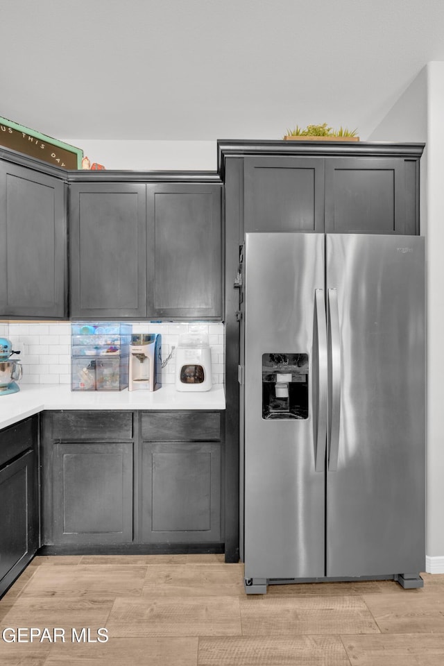 14901 Ted Banks Ave, El Paso, TX 79938 - kitchen featuring stainless steel refrigerator with ice dispenser, decorative backsplash, light countertops, and light wood-style floors