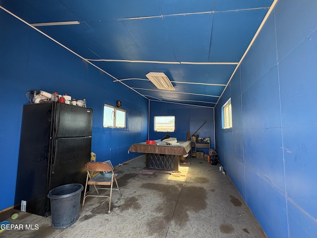 4821 Kreuger St, El Paso, TX 79938 - bedroom featuring freestanding refrigerator, lofted ceiling, and concrete flooring