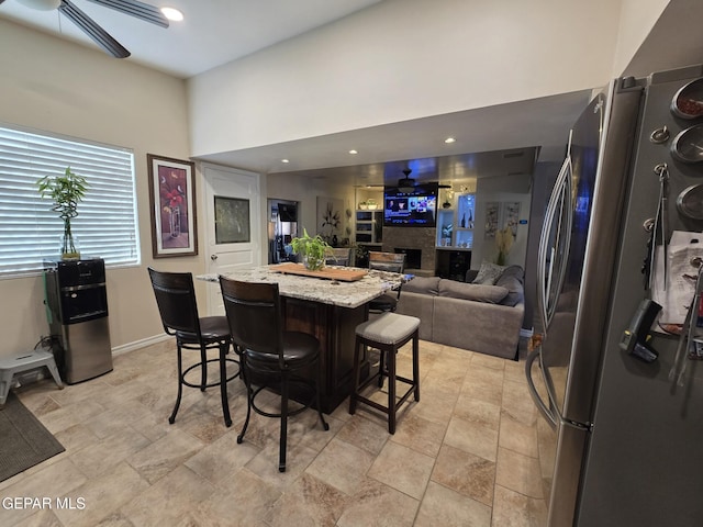 7000 Armistad Ave, El Paso, TX 79912 - dining space with a ceiling fan, stone finish flooring, recessed lighting, and a towering ceiling