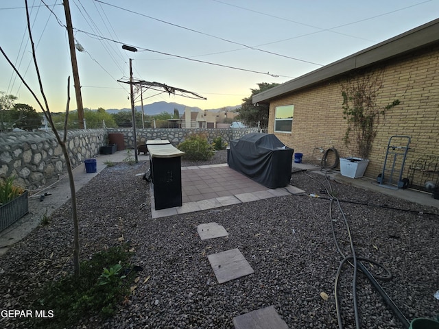 7000 Armistad Ave, El Paso, TX 79912 - yard at dusk featuring a fenced backyard and a patio area