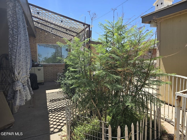 7000 Armistad Ave, El Paso, TX 79912 - view of side of property with brick siding and a patio