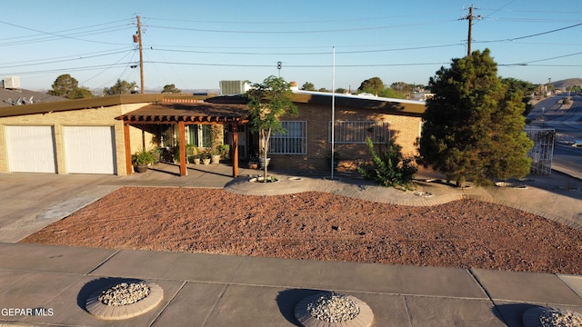 7000 Armistad Ave, El Paso, TX 79912 - single story home featuring brick siding, a pergola, and concrete driveway