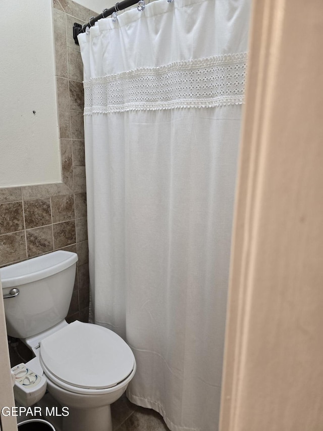 7000 Armistad Ave, El Paso, TX 79912 - bathroom with tile walls and a shower with shower curtain