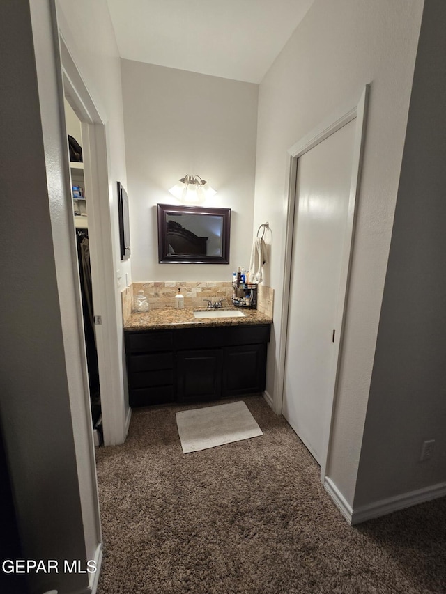 7000 Armistad Ave, El Paso, TX 79912 - bathroom featuring vanity, carpet floors, and a closet