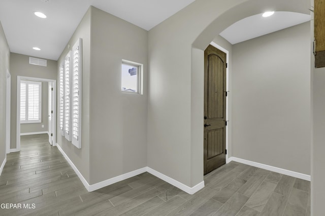 912 Malven Pl, El Paso, TX 79928 - hallway with arched walkways, recessed lighting, and light wood-style floors