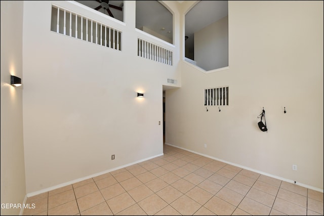 12712 Tierra Aurora Dr, El Paso, TX 79938 - spare room with a ceiling fan, light tile patterned floors, and a towering ceiling