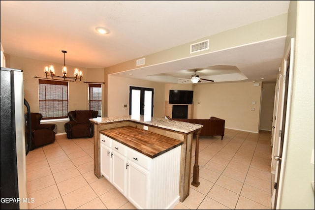 12712 Tierra Aurora Dr, El Paso, TX 79938 - kitchen with open floor plan, light tile patterned floors, freestanding refrigerator, a chandelier, and recessed lighting
