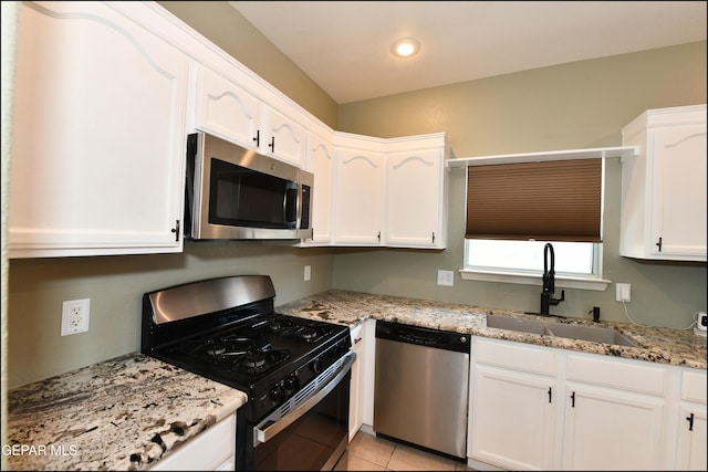 12712 Tierra Aurora Dr, El Paso, TX 79938 - kitchen featuring appliances with stainless steel finishes, white cabinets, light stone countertops, recessed lighting, and light tile patterned flooring
