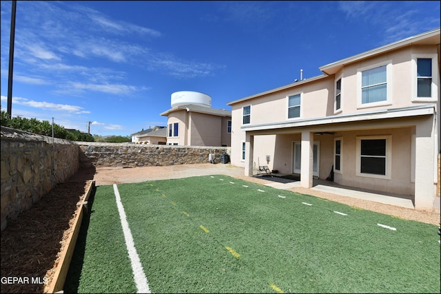 12712 Tierra Aurora Dr, El Paso, TX 79938 - back of house with a fenced backyard, stucco siding, and a patio
