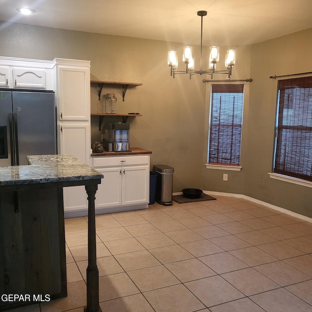 12712 Tierra Aurora Dr, El Paso, TX 79938 - kitchen featuring freestanding refrigerator, white cabinets, light tile patterned flooring, a chandelier, and open shelves