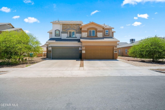 11470 Dawn View Rd Unit B, Socorro, TX 79927 - view of front of home featuring stone siding, stucco siding, an attached garage, and driveway