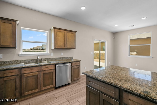 11470 Dawn View Rd Unit B, Socorro, TX 79927 - kitchen featuring stainless steel dishwasher, plenty of natural light, dark stone counters, and recessed lighting