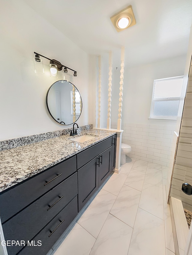 3425 Dialrock Ln, El Paso, TX 79935 - bathroom with vanity, marble finish flooring, and wainscoting
