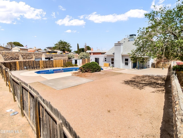 3425 Dialrock Ln, El Paso, TX 79935 - view of swimming pool with a fenced backyard, a patio, and a residential view