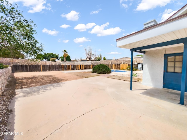 3425 Dialrock Ln, El Paso, TX 79935 - fenced backyard featuring a patio area