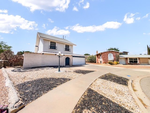 3425 Dialrock Ln, El Paso, TX 79935 - view of front of property featuring driveway, stucco siding, and brick siding