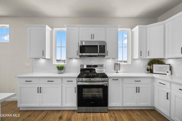 905 Bilton Pl, El Paso, TX 79928 - kitchen featuring stainless steel appliances, white cabinets, tasteful backsplash, and light countertops