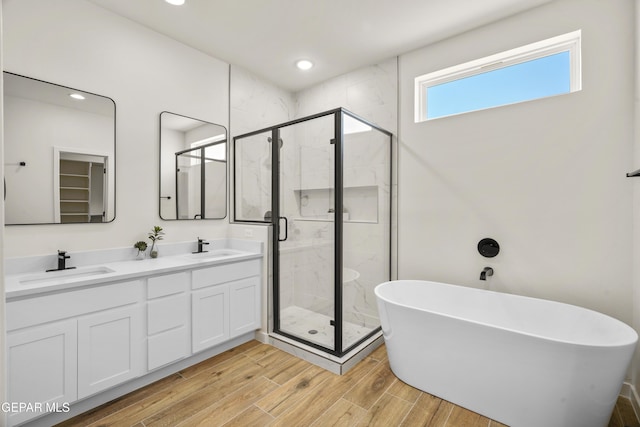 905 Bilton Pl, El Paso, TX 79928 - full bath with a freestanding tub, a stall shower, double vanity, wood finished floors, and recessed lighting
