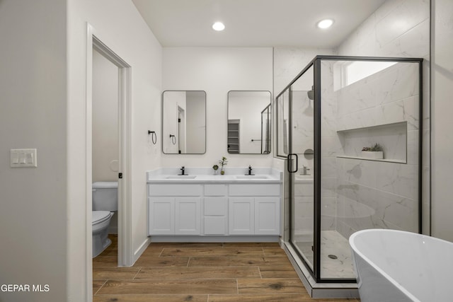 905 Bilton Pl, El Paso, TX 79928 - full bath featuring a freestanding bath, double vanity, a stall shower, wood finished floors, and recessed lighting