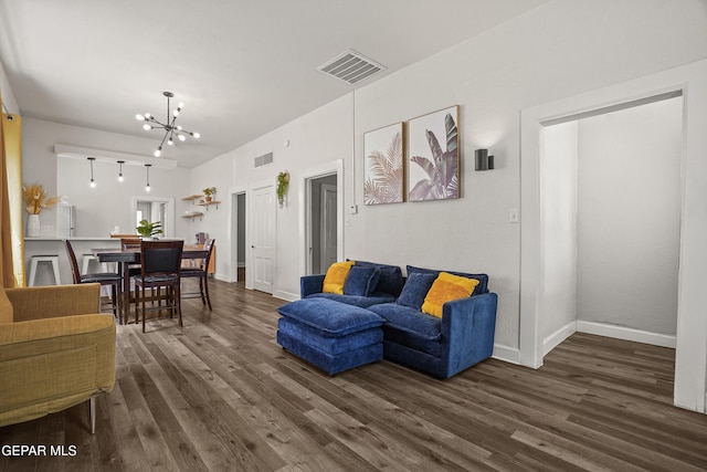 3031 Memphis Ave, El Paso, TX 79930 - living room with a chandelier and dark wood-type flooring