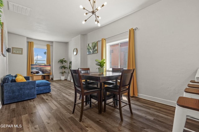 3031 Memphis Ave, El Paso, TX 79930 - dining area featuring dark wood-style flooring and a chandelier