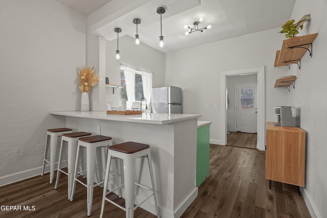 3031 Memphis Ave, El Paso, TX 79930 - kitchen featuring freestanding refrigerator, dark wood finished floors, a peninsula, and plenty of natural light